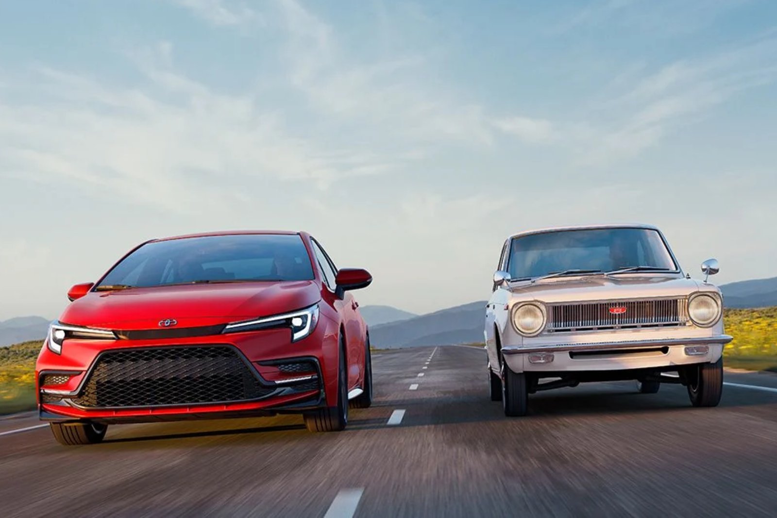 A new red Toyota Corolla sedan driving side by side with a white first-generation Corolla from the 1960s on an open road